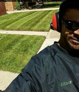 Lawn care provider cutting a lawn in Hazel Park, Michigan