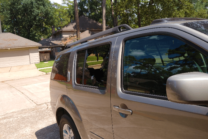 A broken car window due to a rock - lawn and landscaping accident