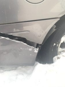 Cracked car bumper due to a snow plow blade - lawn and landscaping accident
