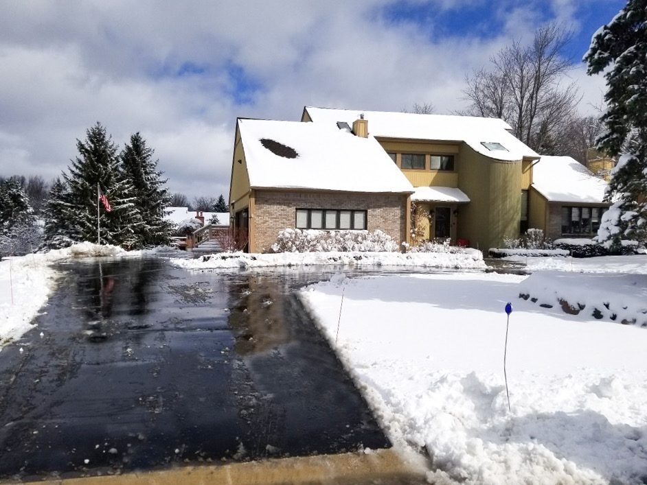 Snow removed from driveway in Clarkston Michigan with salt application
