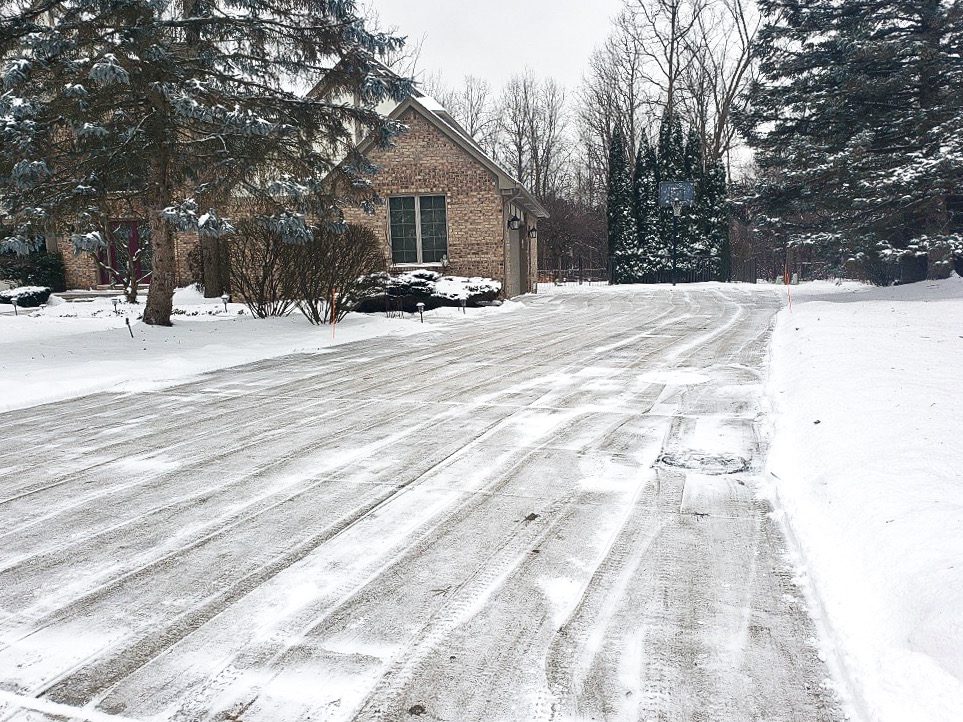 A driveway freshly plowed after a heavy snowfall in Michigan