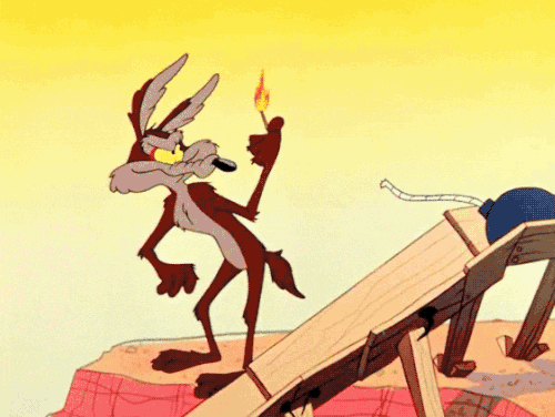Wile E Coyote lighting off a fireworks and burning himself
