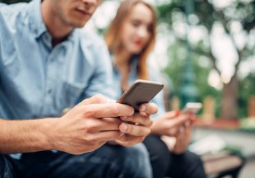 Phone addicted people, couple using smartphones