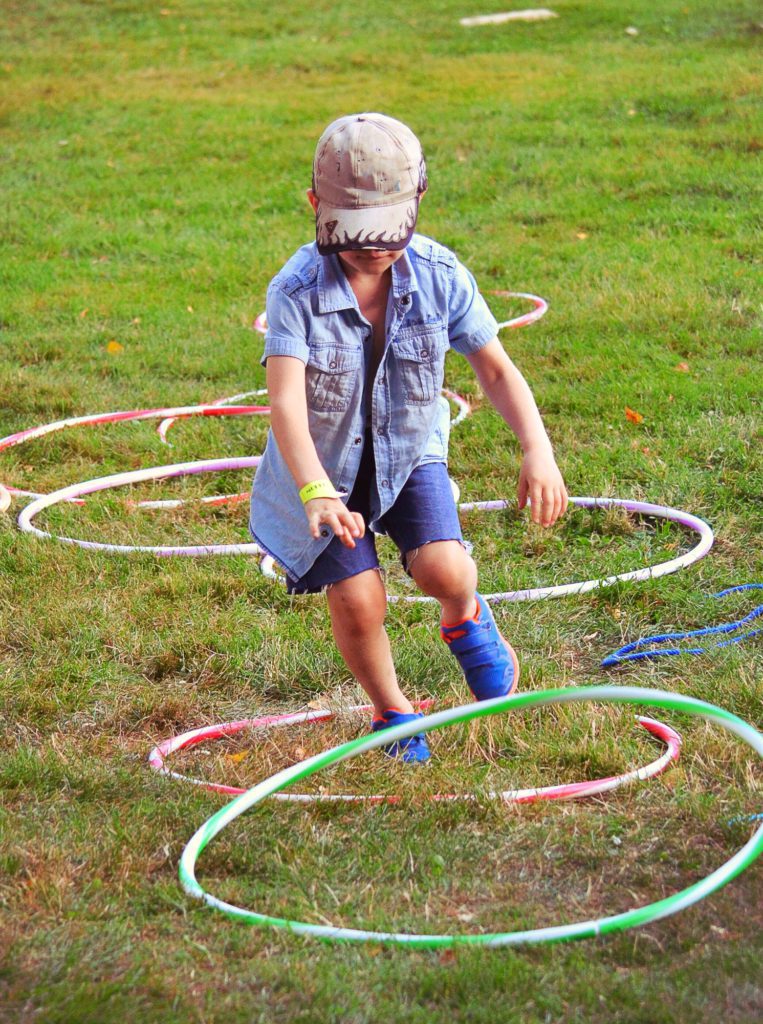 Boy playing with hula hoops