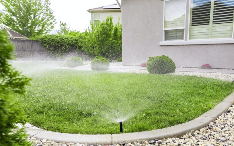 Freshly mowed lawn with sprinkler system in Oak Park Michigan