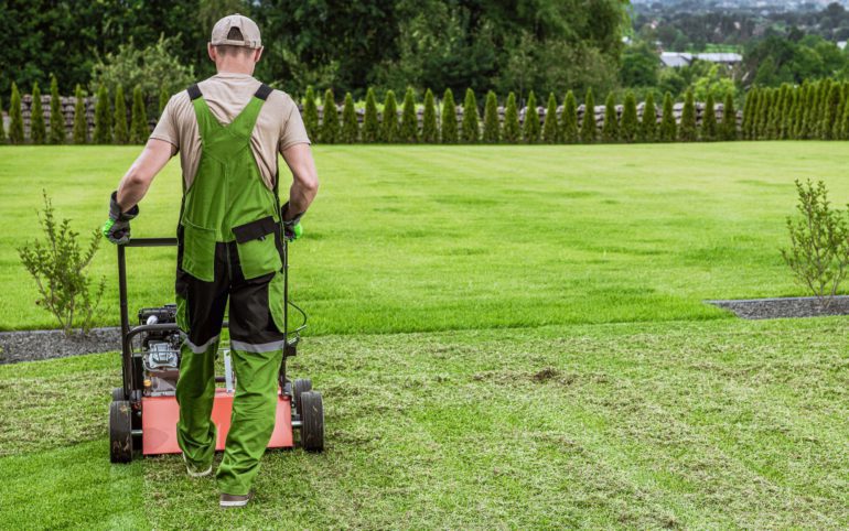 Gardener in His 40s and His Powerful Gasoline Lawn Aerator